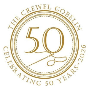 The Crewel Gobelin gold circular emblem celebrating 50 years, 1976-2026, featuring ornate serif numerals and decorative flourish